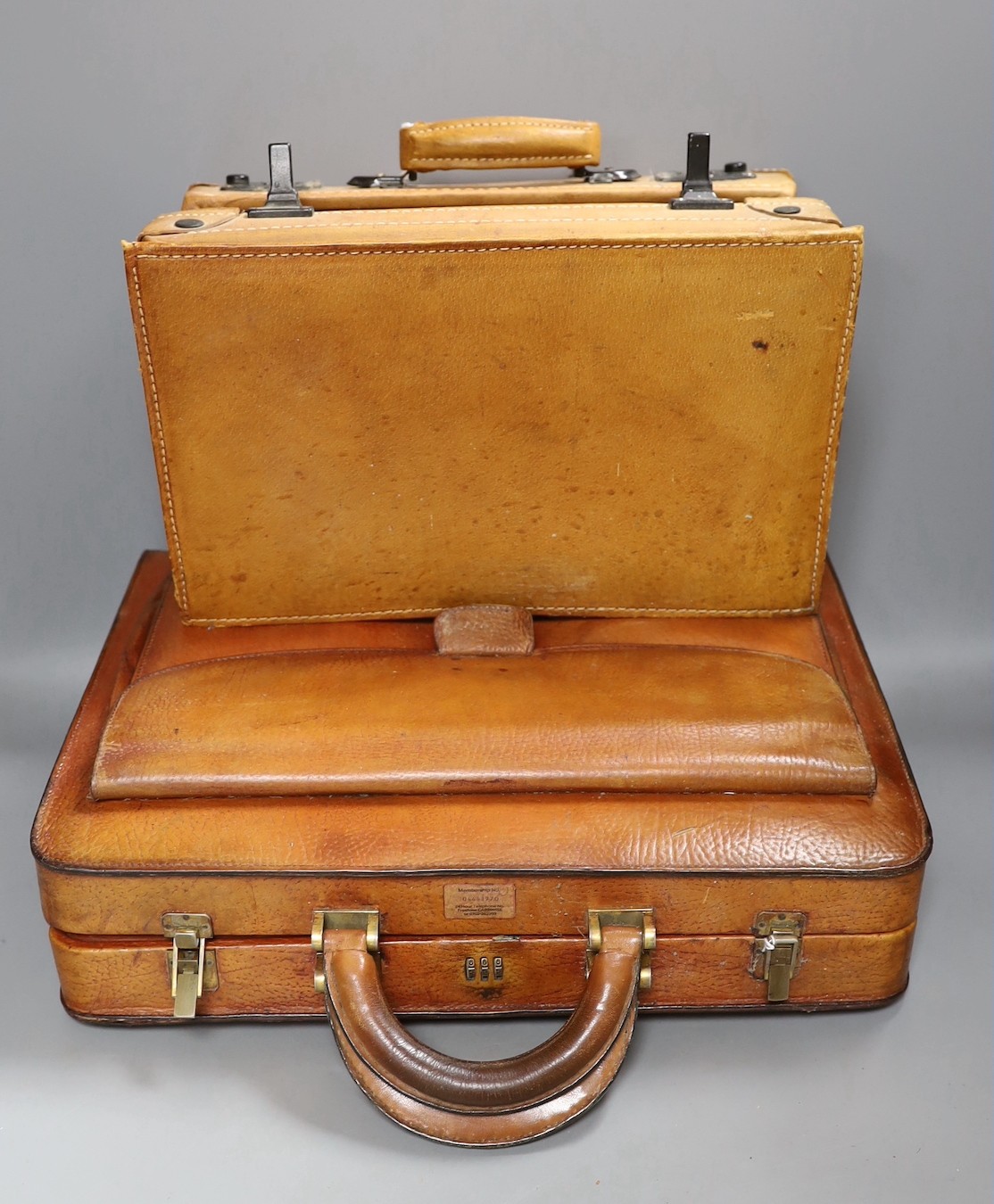 A vintage brown leather briefcase with integrated lock system, together with another Italian Giovanni briefcase